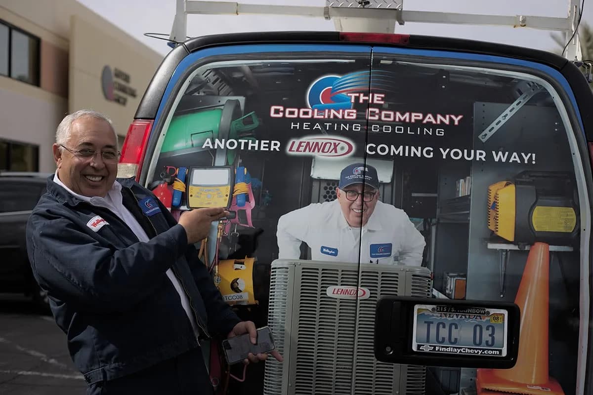 Wellington Santana, Co-CEO and founder, standing beside TCC service van