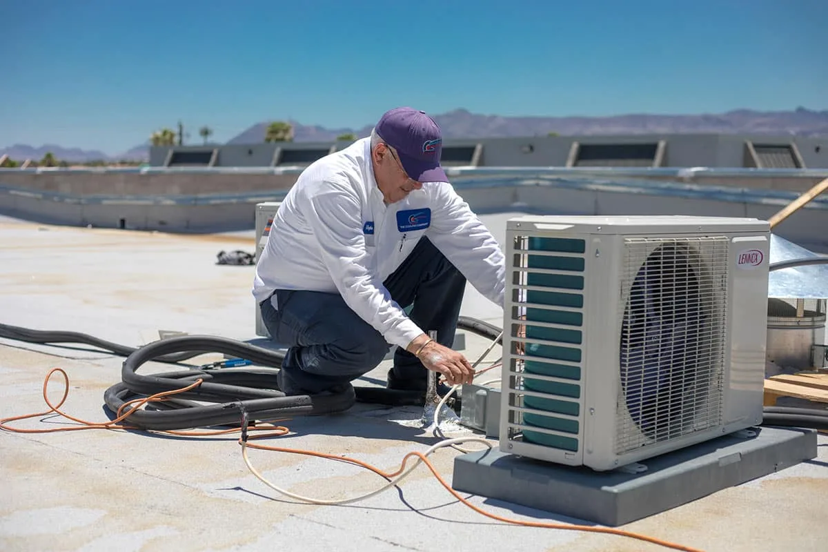 The Cooling Company technician servicing HVAC equipment - warranty transferability: a critical factor