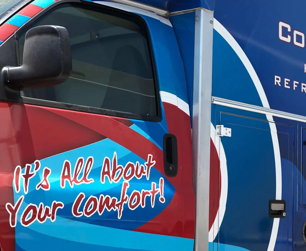 Cooling Company technician standing by a service van