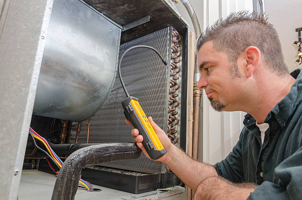 Technician diagnosing a water heater system